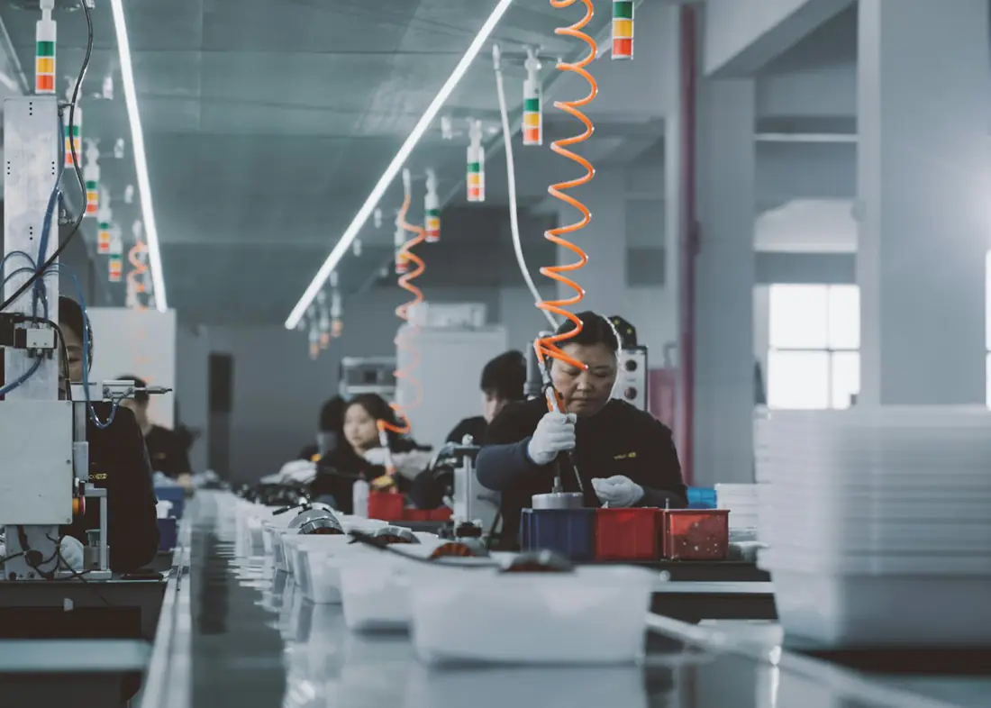 Workers on an electronics assembly line