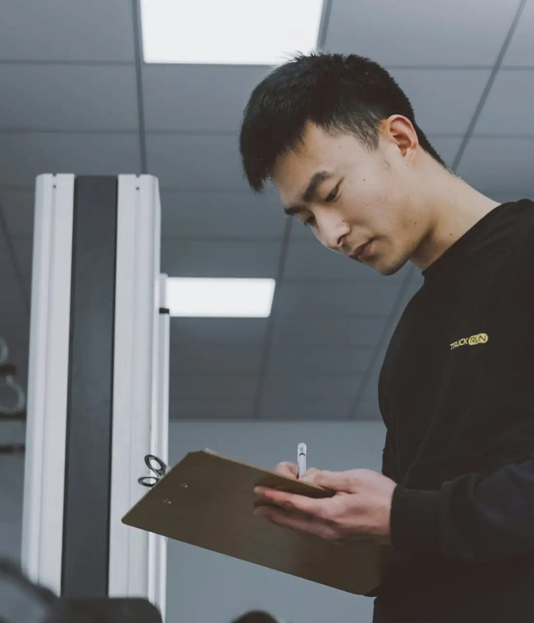Inspector with a checklist on a factory floor